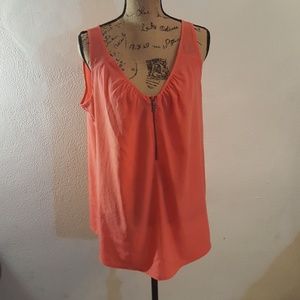 Sleeveless zipper down front shirt.